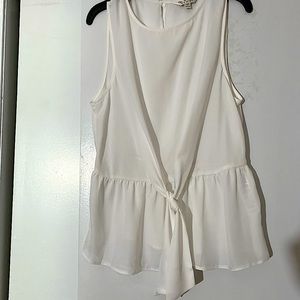 White sleeveless top, new but missing tag. Button at back, sheer